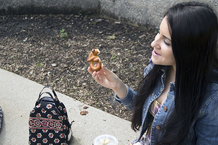 Chatting with her friends, junior Amelia Andrews munches on a prezel. Andrews said nearly any food can be turned vegan. “I don’t feel deprived,” she said.