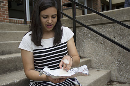 Unwrapping her lunch, junior Daniela Litardo prepares to eat a slice of turkey. Litardo attempts to follow the Whole 30 diet 5 times throughout the year. “I mainly eat simply, which means that I eat a lot of vegetables,” Litardo said.