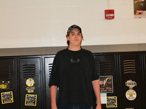  Junior Andrew Kerr stands in his usual t-shirt, jeans, and baseball cap. He said he wears t-shirts because they’re comfortable and easy. “And remember: too tight ain’t right,” he said. 