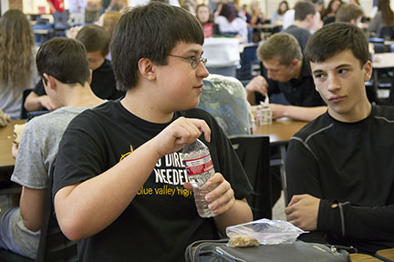 Setting down his sandwich, junior Nathan Luzum takes a drink of water. Luzum was raised vegetarian. “I hadn’t eaten with people who were actually eating meat a lot” Luzum said.