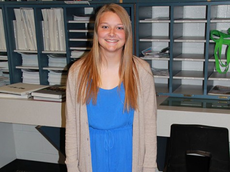 Sophomore Taylor Holtmeyer poses in a blue dress and cream-colored cardigan. She said she always finds a way to put blue into her outfit. “Blue is my favorite color, I love to wear it because it matches my eyes,” she said.