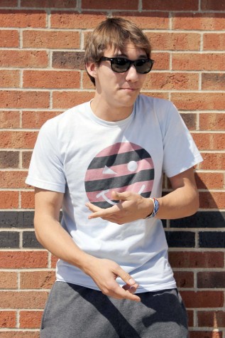 Senior Charlie Williams practices rapping outside the school. Williams said he enjoys rapping outdoors because it gives him an excuse to wear his sunglasses. “I need to bring back that funky style — I feel like I’m funky,” Williams said. Photo by Molly Johnson.