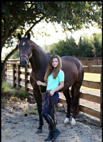  Senior Alexis Vance is standing by her strongest companion, and best friend, Encore. Vance has been riding for over ten years now, and is ready to follow through with her lifelong ambitions. “Life is like a horse” Vance said. “If it tries to buck you off, just hold on a little tighter.” Photo by Loren Reed