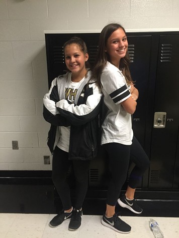 Sophomore twins, Anna and Abby Quigley, pose back to back in the halls of Blue Valley. The Quigley’s both participate in cheer at the school and are shown wearing spirit wear. “Cheer is one of the many things we enjoy doing together,” Anna said. Photo credited to Emma Andersen.