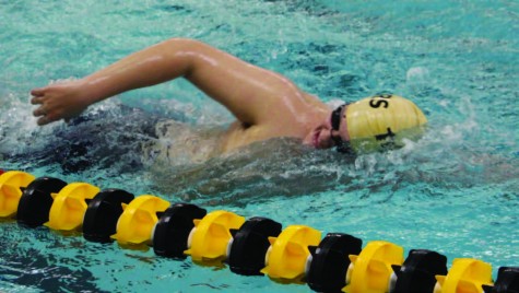 For his warm-up, senior Adam Houghton swims freestyle. The swim team practice 10 times per week, both before and after school. “It’s a lot of muscle memory,” he said. “If you do it repeatedly, you get better at it.”