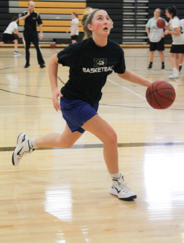  Dribbling the ball, junior Katie Beth Jones runs down the court. Jones has played on varsity since her freshman year. “We had a lot of senior leaders last year, so the juniors are going to need to take it upon ourselves to lead the team more,” she said. 