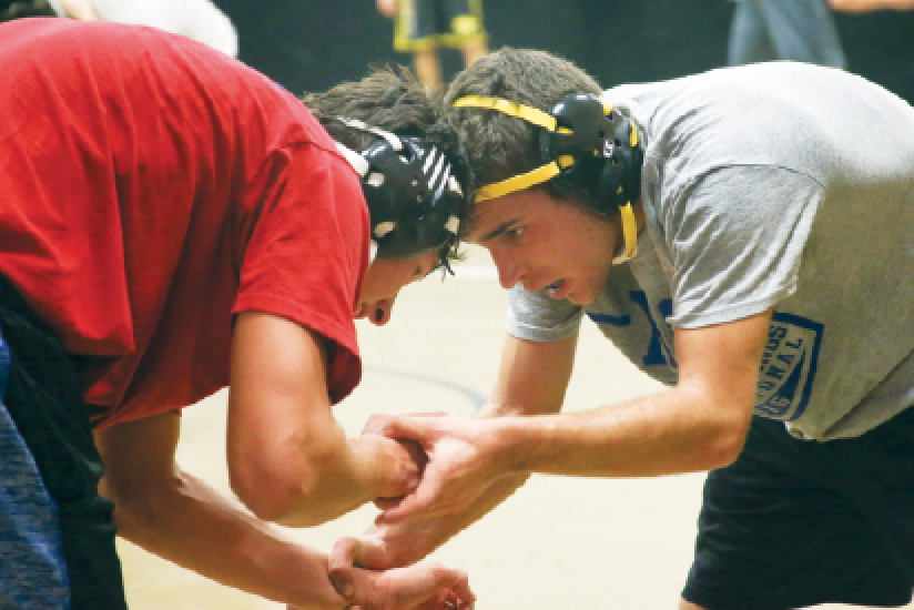 Facing his opponent, junior Grant Boehringer assumes neutral power position. You can score points in wrestling with a take-down or escape. “I love the competition and grit necessary to wrestle,” he said. 
