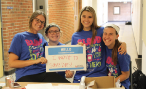 Junior and senior representatives check students into the blood drive from the table outside the gym. The drive took place on Nov. 9. “I really like seeing how many people choose to donate because it’s sort of a scary thing but it makes a huge impact on someone else’s life,” senior Gracie Salts said. “Being a part of that is an amazing feeling.” Photo by Abby Hullinger. 