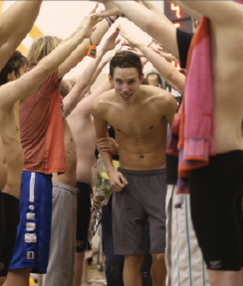 During Senior Night, senior Owen Andersen walks through the spirit tunnel. The swim team competed against Saint James Academy Jan. 18. “[This season] I want to break my own record and place top-8 at State” Andersen said.