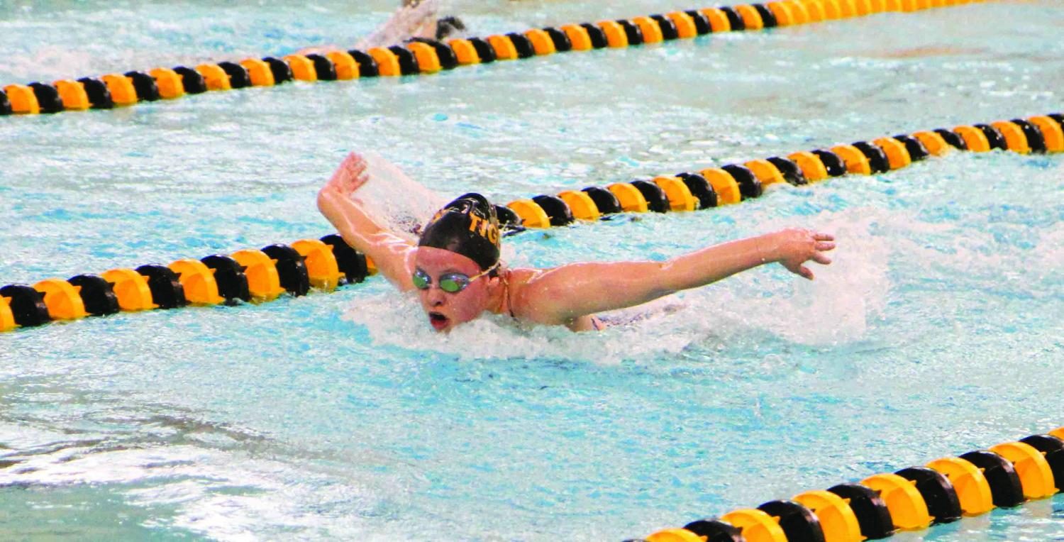 Swimming butterfly, junior Audrey Hawn competes in a swim competition. She has been on the swim team for three years. “I like the team camaraderie and how it’s an individual sport but you also compete as a team,” she said. 