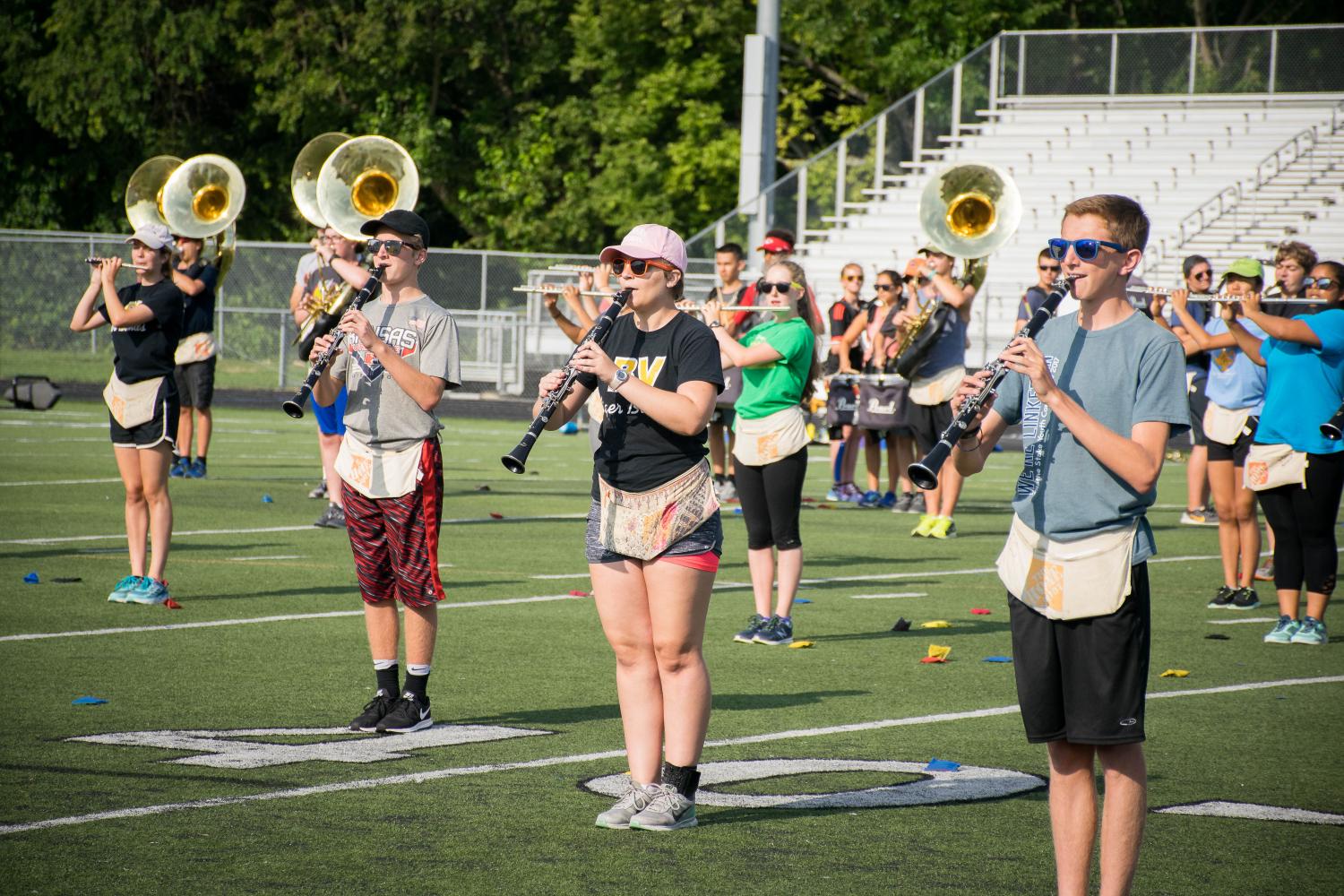 Standing in place, senior Madison Ashworth plays the flute with her bandmates. “Rehearsing is worth it because you are contributing to something that is so much more than you. You are just one dot in a huge picture,” she said.