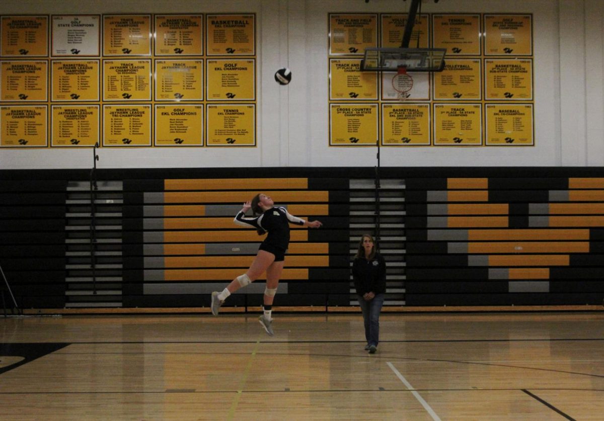 Jumping in midair, sophomore Evelyn Diederich serves the ball. Diederich has been playing volleyball since second grade. “My favorite part about [volleyball] is moving from club to high school and playing with a new group of teammates,” she said. 