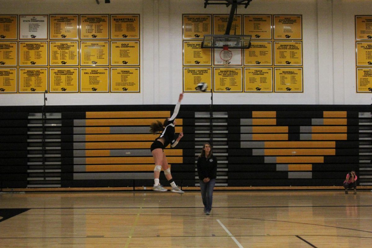 Following through, sophomore Evelyn Diederich finishes her serve. Diederich scored the winning ace of the game. “It took me awhile to learn to serve the way I do, so it feels nice to know that my work is paying off when I get an ace,” she said.  