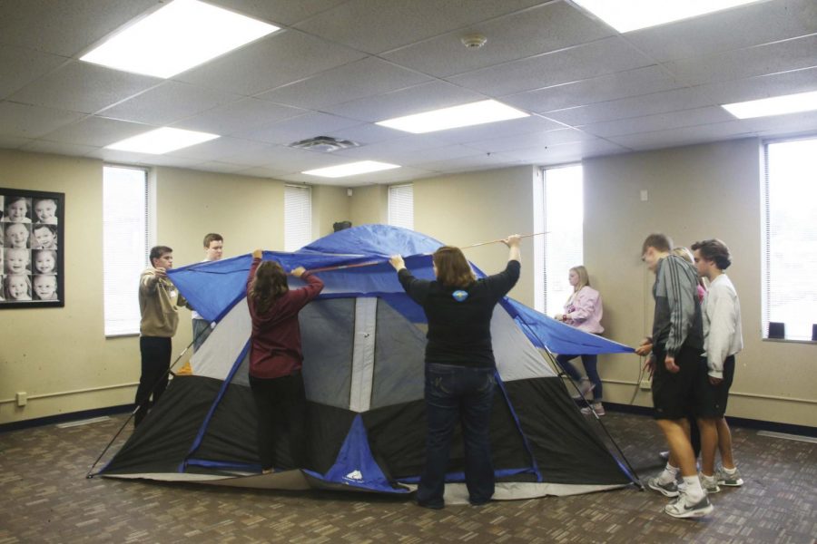  Senior Cody Zakeri assists in putting up a tent at the Down Syndrome Guild. “We helped them clean the basement and get their stuff organized for an event they were having that night,” he said. 