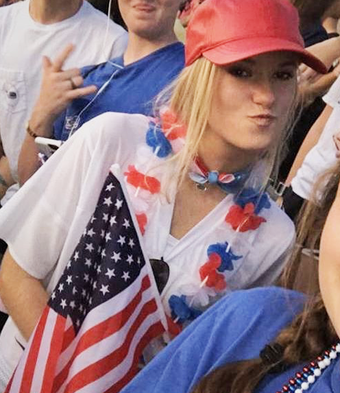 At a football game, freshman Ann Heitman waves her flag. The theme for the game is USA, voted on by Student Council. I love going out to different activities and supporting my school, Heitman said. PHOTO BY EMILY BRIXEY-THATCHER.