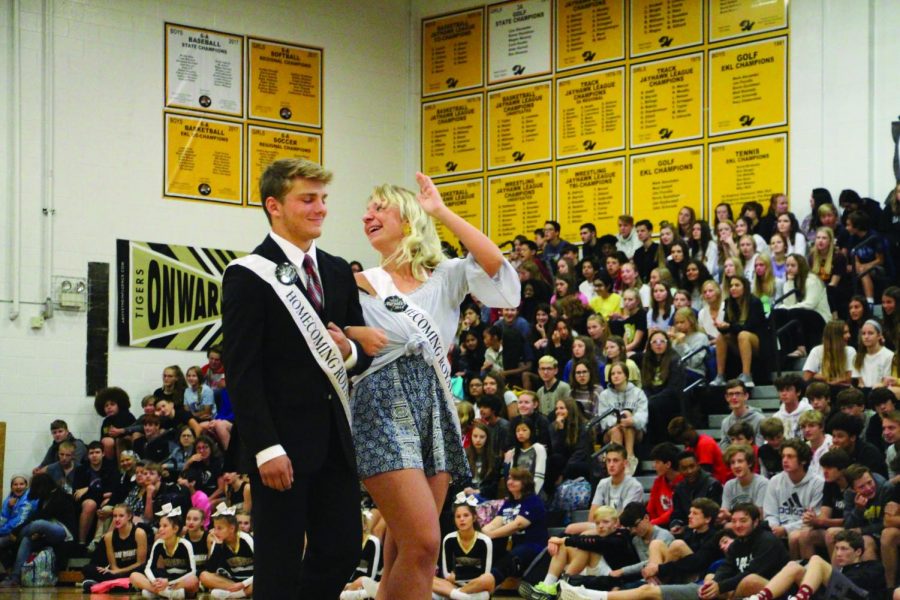 Waving to the students, senior Allie Ament walks as a candidate for Homecoming Queen at the assembly. “It was such an honor,” Ament said. “I appreciate everyone letting me be a princess for a week.”