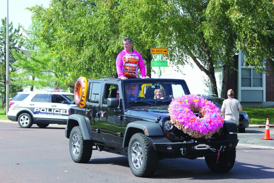 Dressed in his traditional donut float attire, principal Scott Bacon rides in the Homecoming parade. The Homecoming parade route began at the Walmart on Metcalf Avenue and finishes at Stanley Elementary.