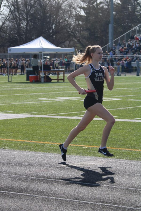 Sophomore Ava Meissner runs in a relay. “It’s fun to cheer on my friends and just have [fun] competing,” Meissner said.