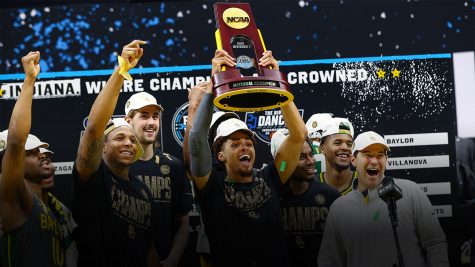 2021 Champions Baylor Bears hold the victory trophy in the midst of confetti after winning the National Championship game